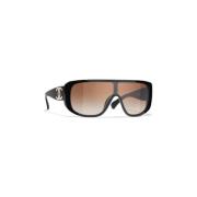 Elegante svarte solbriller med brune linser